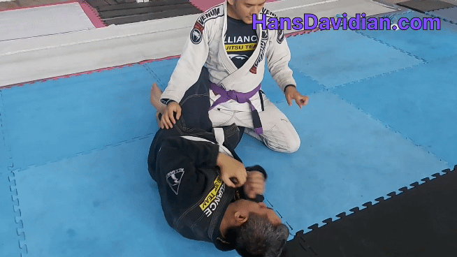 The first step of this half guard pass is to attach the free knee to your opponent's hip.